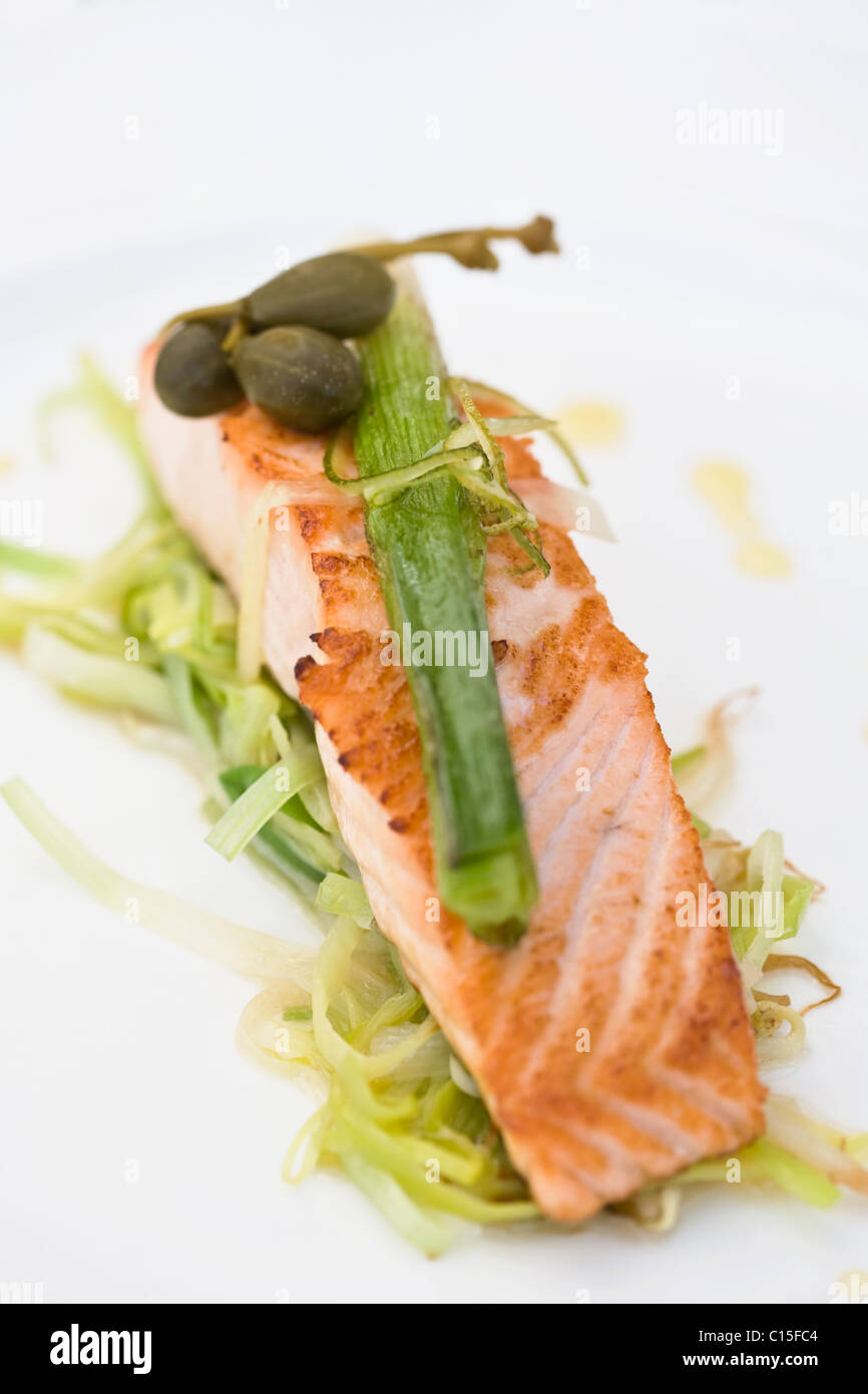 Panfried salmon toped with leeks and capers Stock Photo Alamy