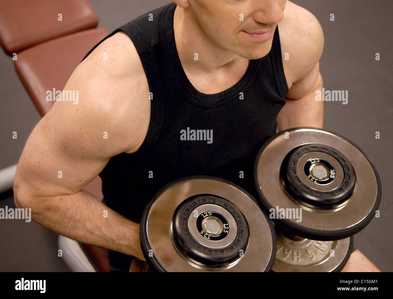 Man lifting weights GYM Muscle fitness Stock Photo