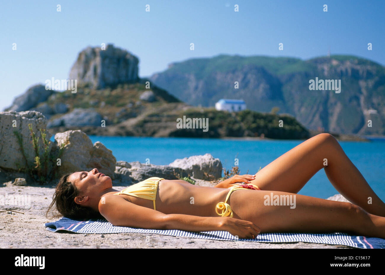Woman sunbathing, tanning, Agios Stefanos, Kos, Dodecanese Islands, Greece Stock Photo