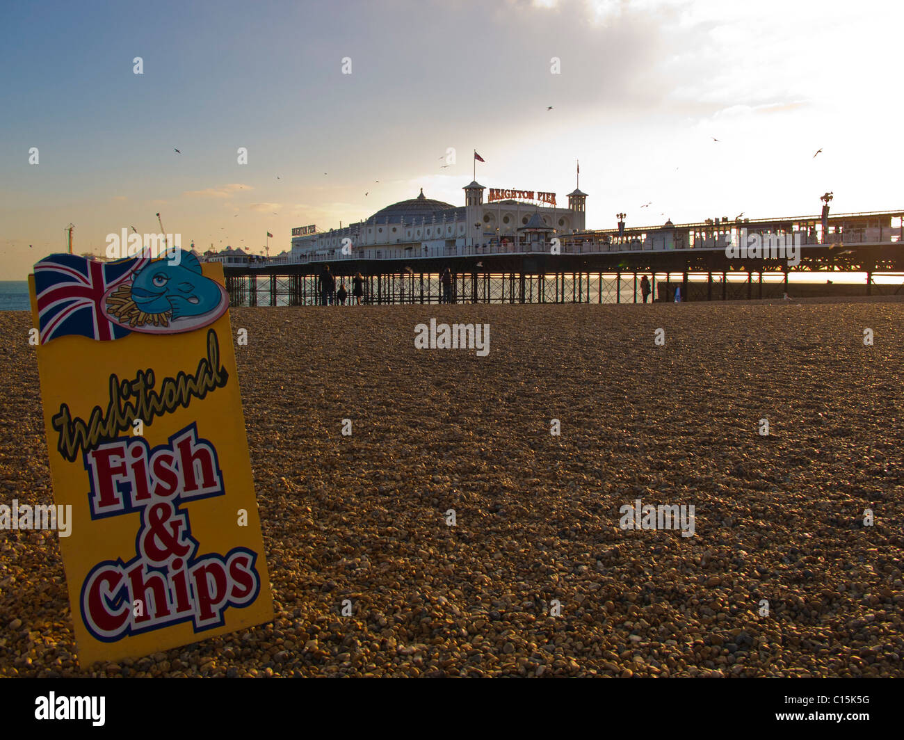 View across to Brighton Pier with Traditional Fish and Chips sign. Stock Photo