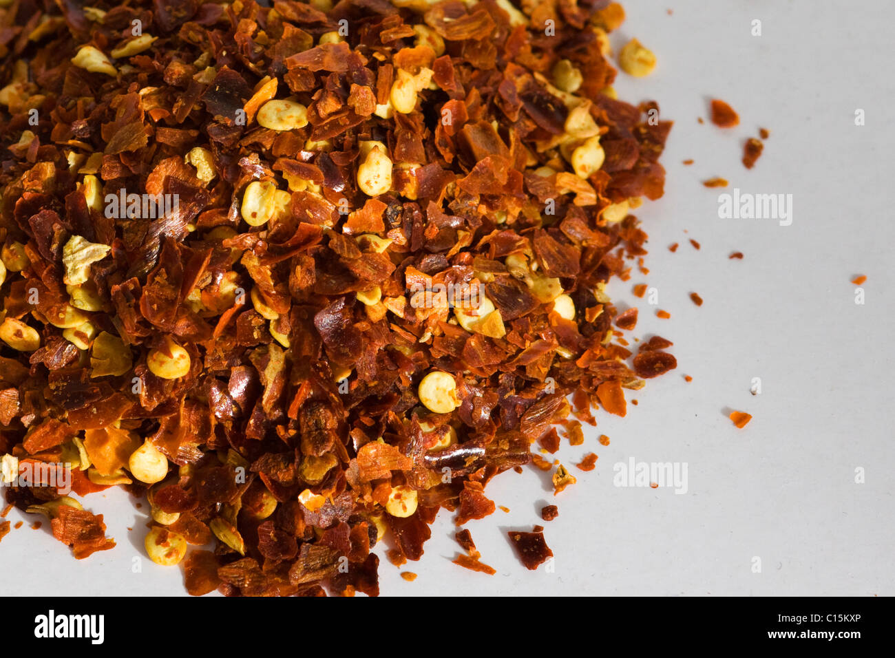 Crushed Chilli's on a white background Stock Photo