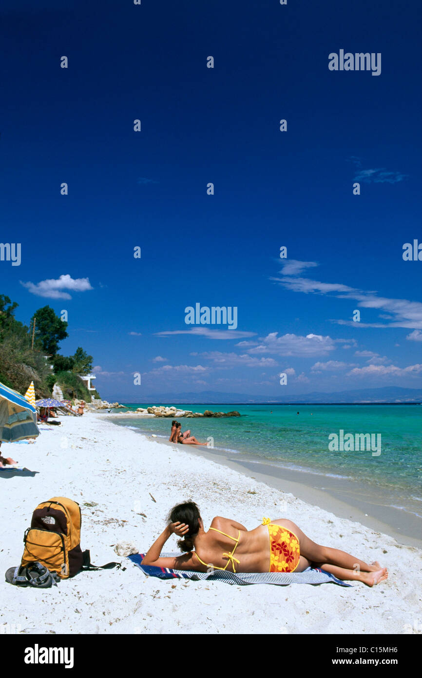 Woman sunbathing on a beach, Afithos, Kassandra, Chalkidiki, Greece, Europe Stock Photo