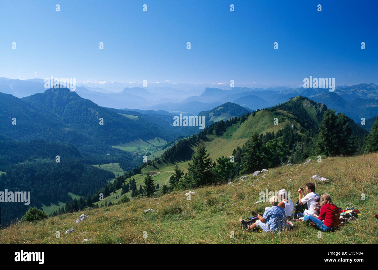 Hikers taking a rest, Mt. Hochries, Chiemgau, Bavaria, Germany, Europe Stock Photo