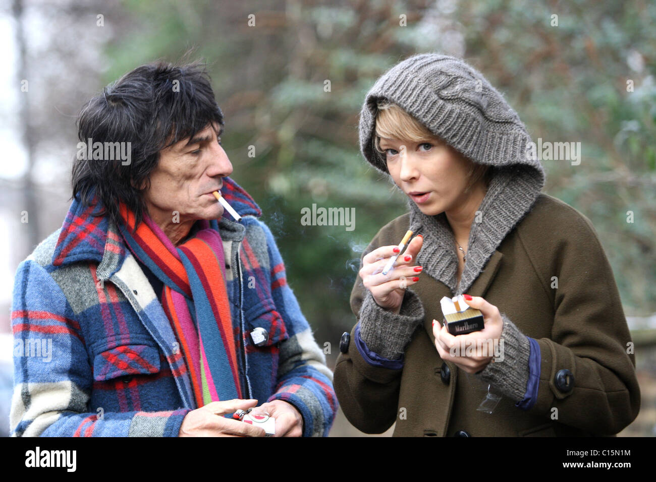 Ronnie Wood and girlfriend Ekaterina Ivanova enjoy a cigarette together while out and about in North London London, England - Stock Photo