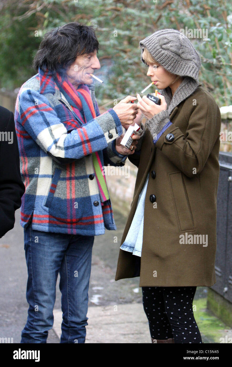 Ronnie Wood and girlfriend Ekaterina Ivanova enjoy a cigarette together while out and about in North London London, England - Stock Photo