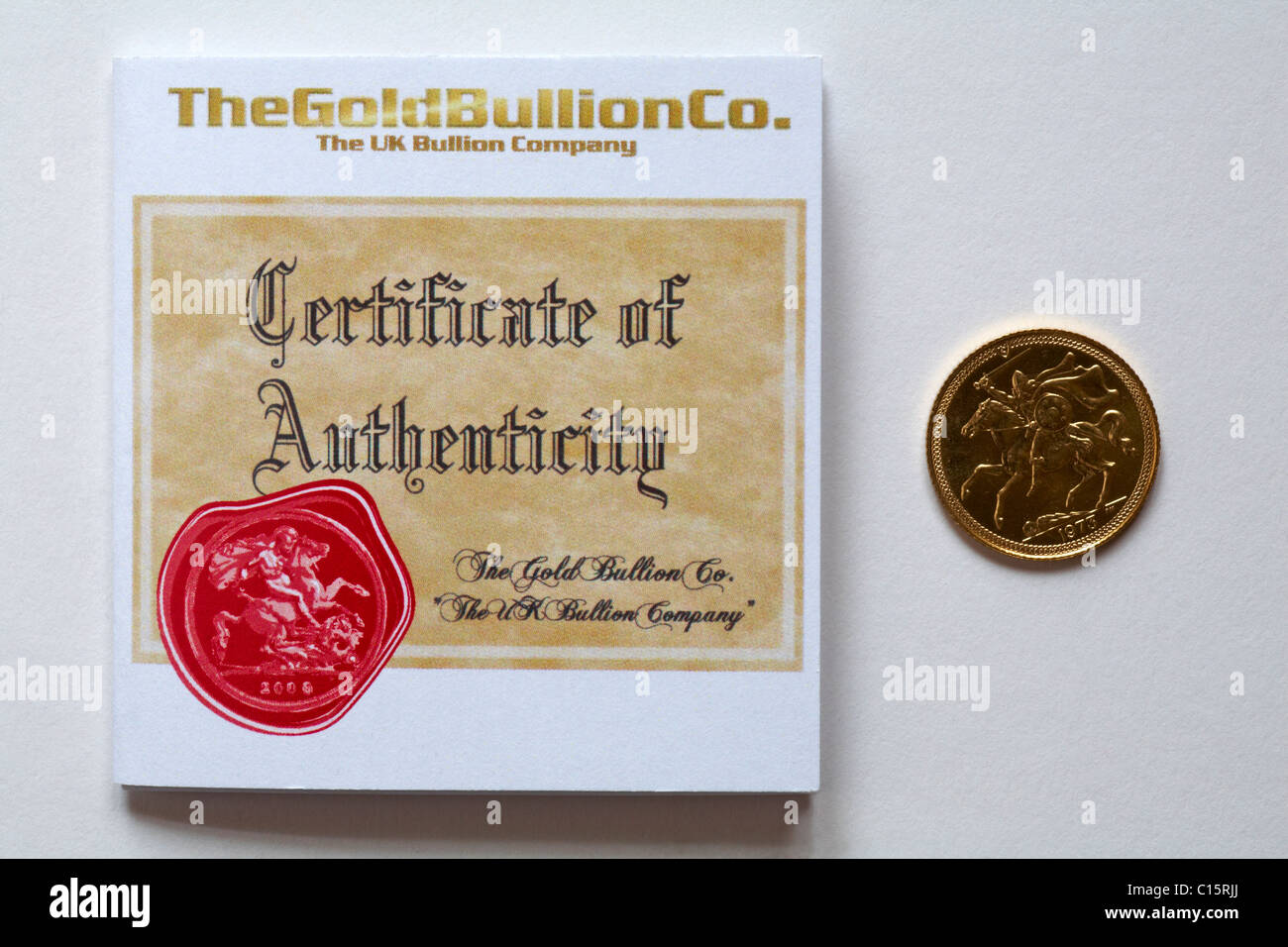 Gold half sovereign with certificate of authenticity issued by The Gold Bullion Co, the UK Bullion Company, on white background Stock Photo