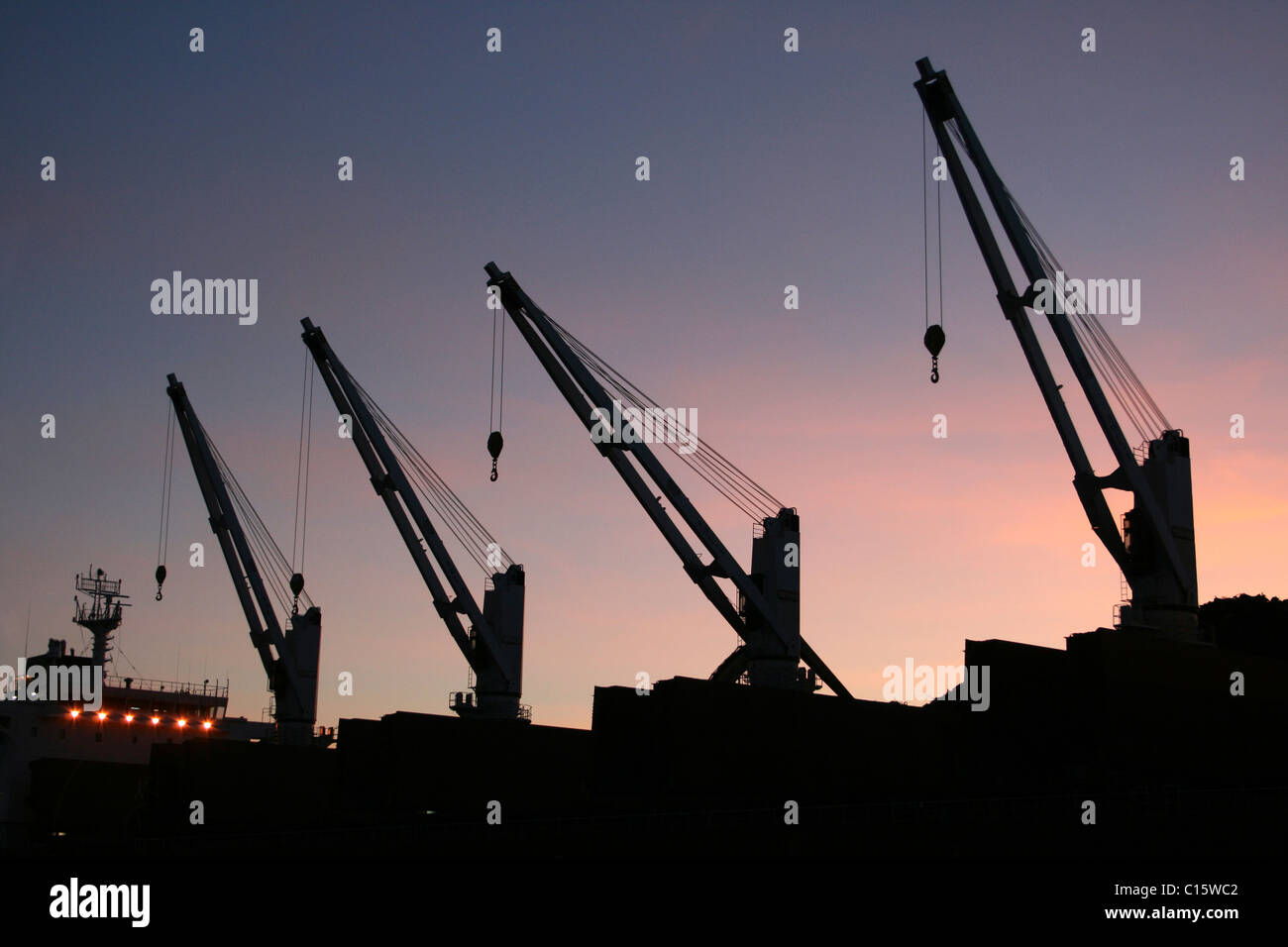 Ship Cranes Silhouetted At Sunset, Liverpool Docks, UK Stock Photo
