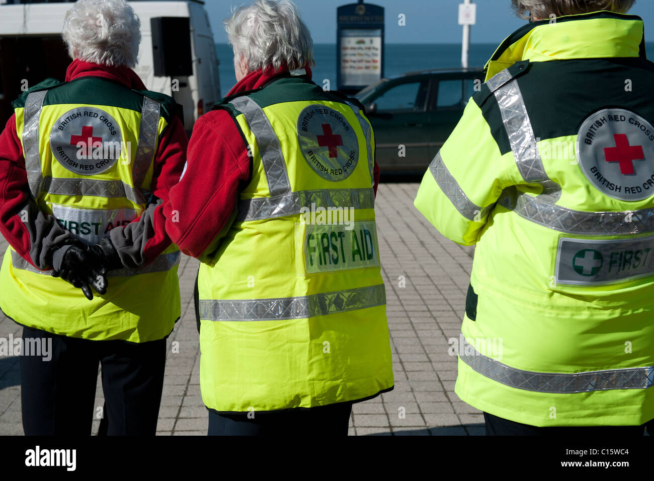 Rear view of three British Red Cross first aid volunteers, UK Stock Photo