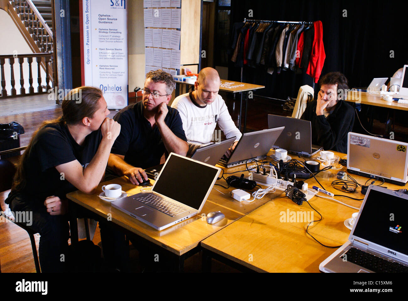 Open source software developers working together at a 'hackathon' meetup. Stock Photo