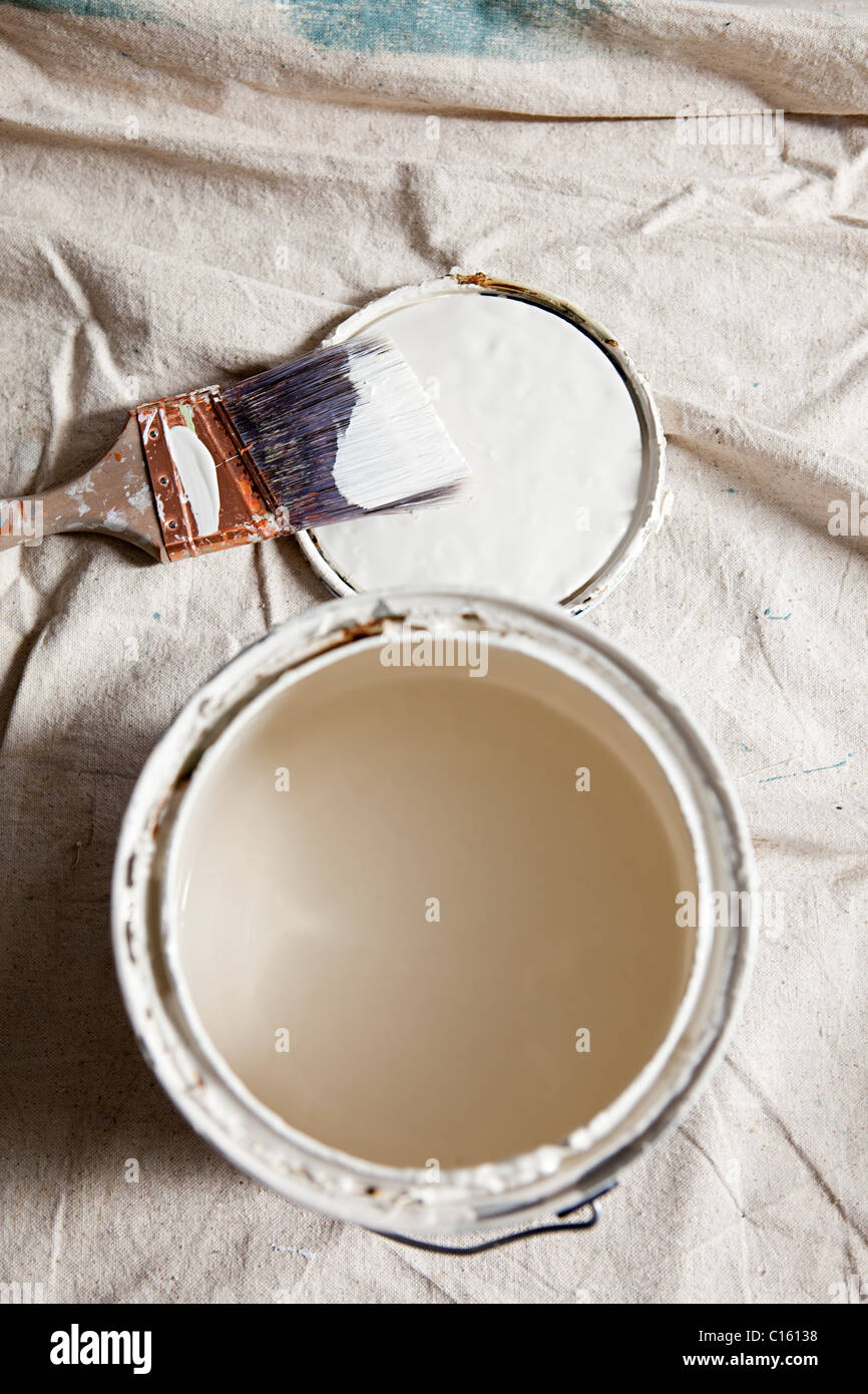 Open paint tin with white paint Stock Photo