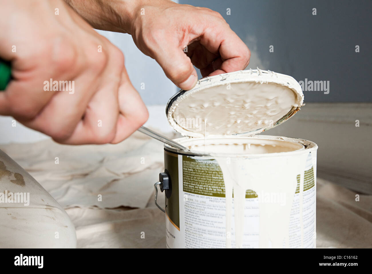 Man opening paint tin Stock Photo Alamy
