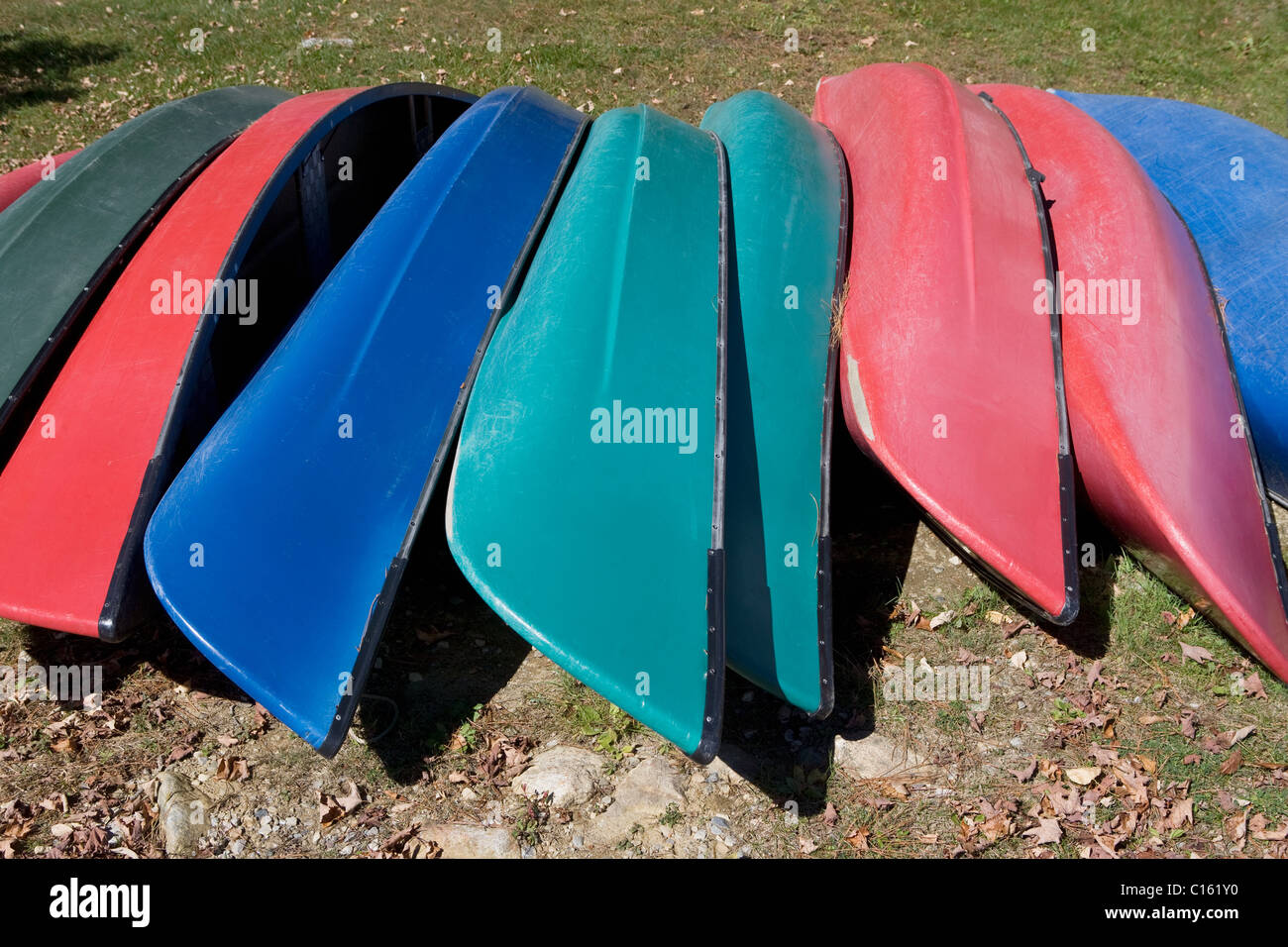Canoes upside down in a row Stock Photo Alamy
