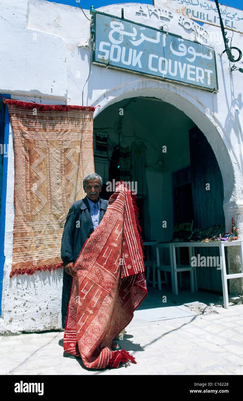 Carpet vendor, man selling rugs at a souk, Houmt Souk, Djerba, Tunisia