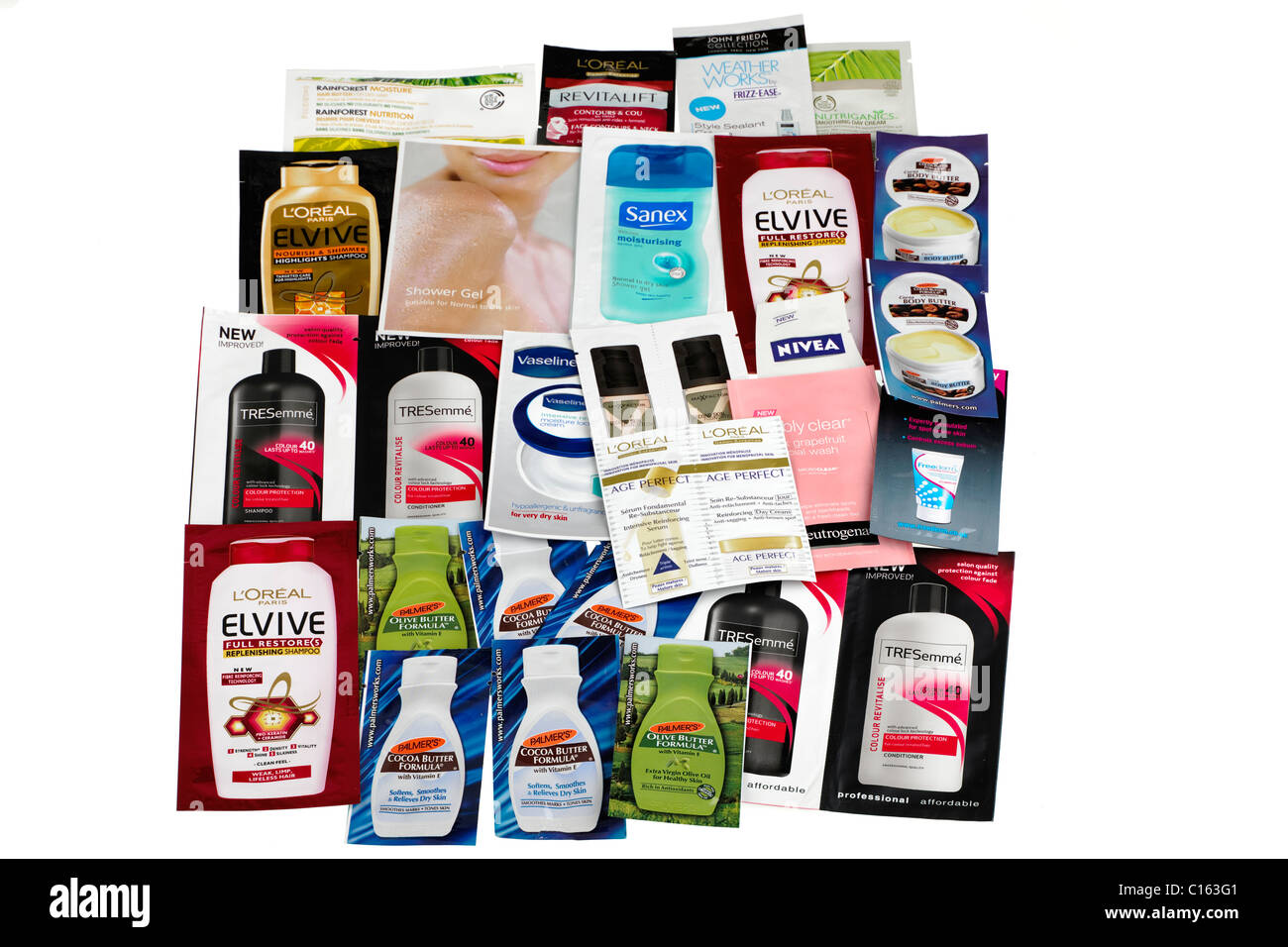 Pile of mixed free skin body shampoo sample sachets Stock Photo