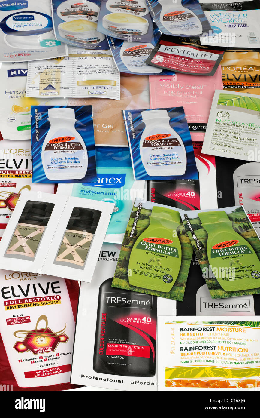 Pile of mixed free skin body shampoo sample sachets Stock Photo