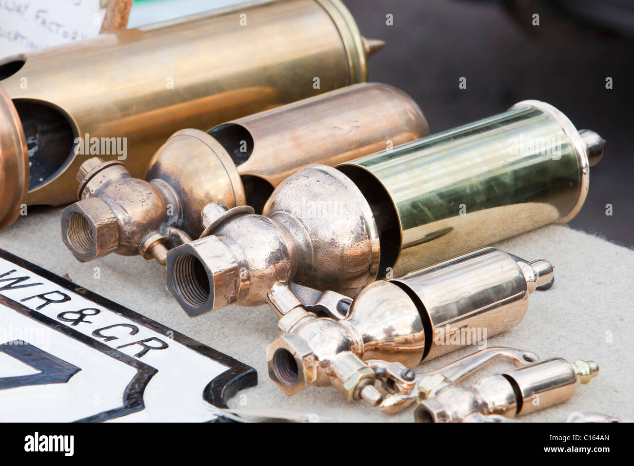 Old steam train brass whistles at a railway enthusiasts sale in