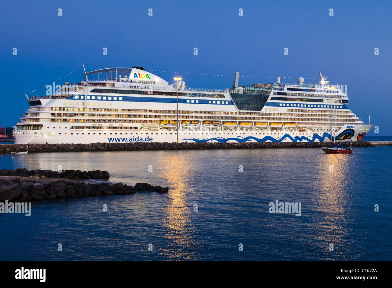The luxury cruise liner AIDAblu at dusk leaving the harbour of Puerto del Rosario on the Canary Island of Fuerteventura Stock Photo