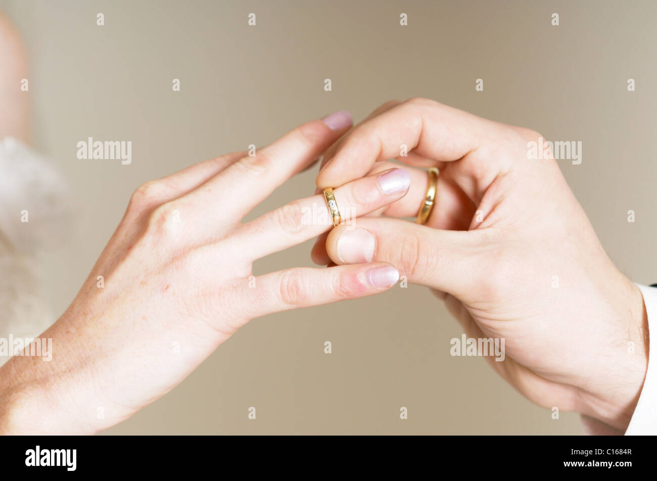 Bridegroom placing wedding ring on the bride's finger Stock Photo