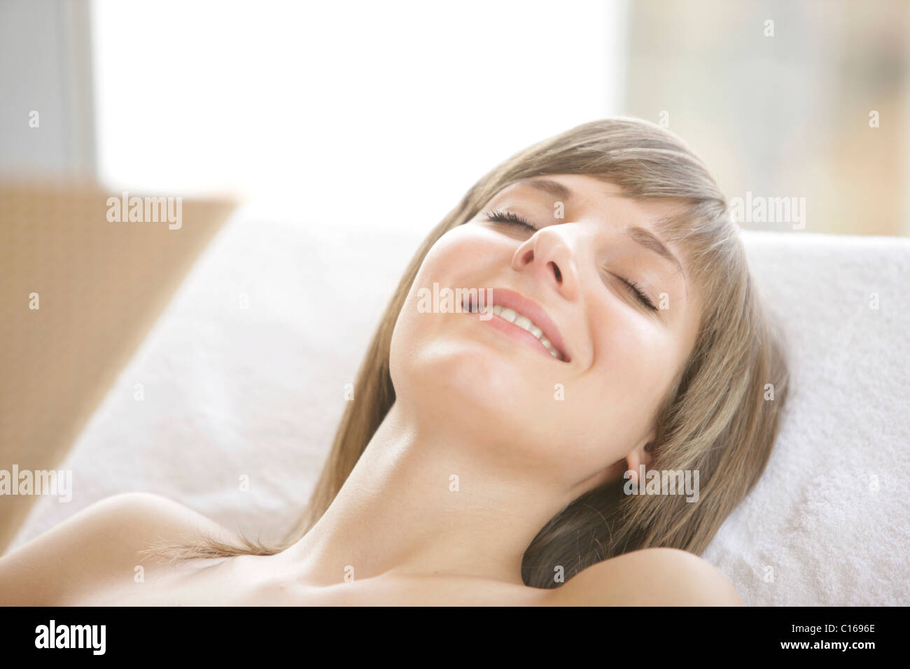 18-year-old girl lying on a deck-chair, closed eyes Stock Photo