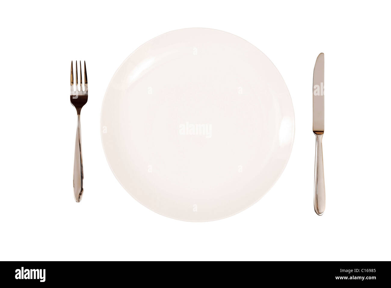 White plate with knife and fork isolated on a white background. With clipping path Stock Photo