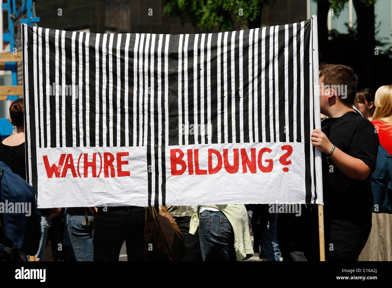 Student holding a banner, bar-code, reading Wahre Bildung, good education, student demonstration for the abolition of student Stock Photo