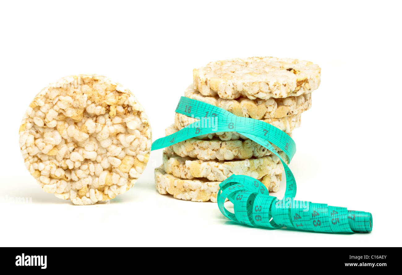Low fat rice cakes with tape measure sliming concept on white Stock Photo Alamy