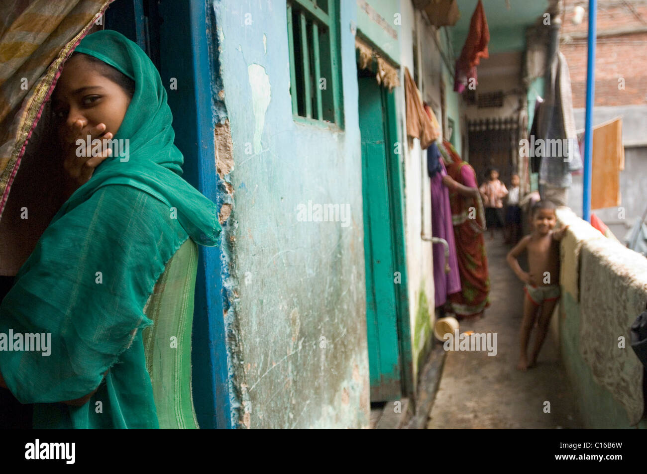 Although the predominantly Muslim slum dwellers are relatively open and approachable, this girl feels embarrassed about being Stock Photo