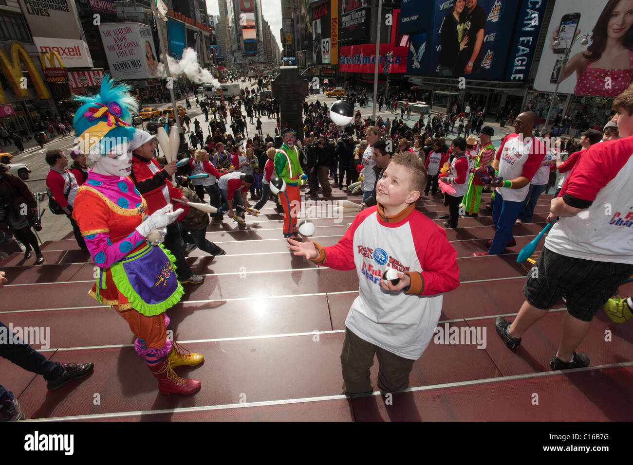 Clowns and other workers from the Ringling Bros. Barnum & Bailey Circus juggle in Times Square as a 'flash mob' Stock Photo
