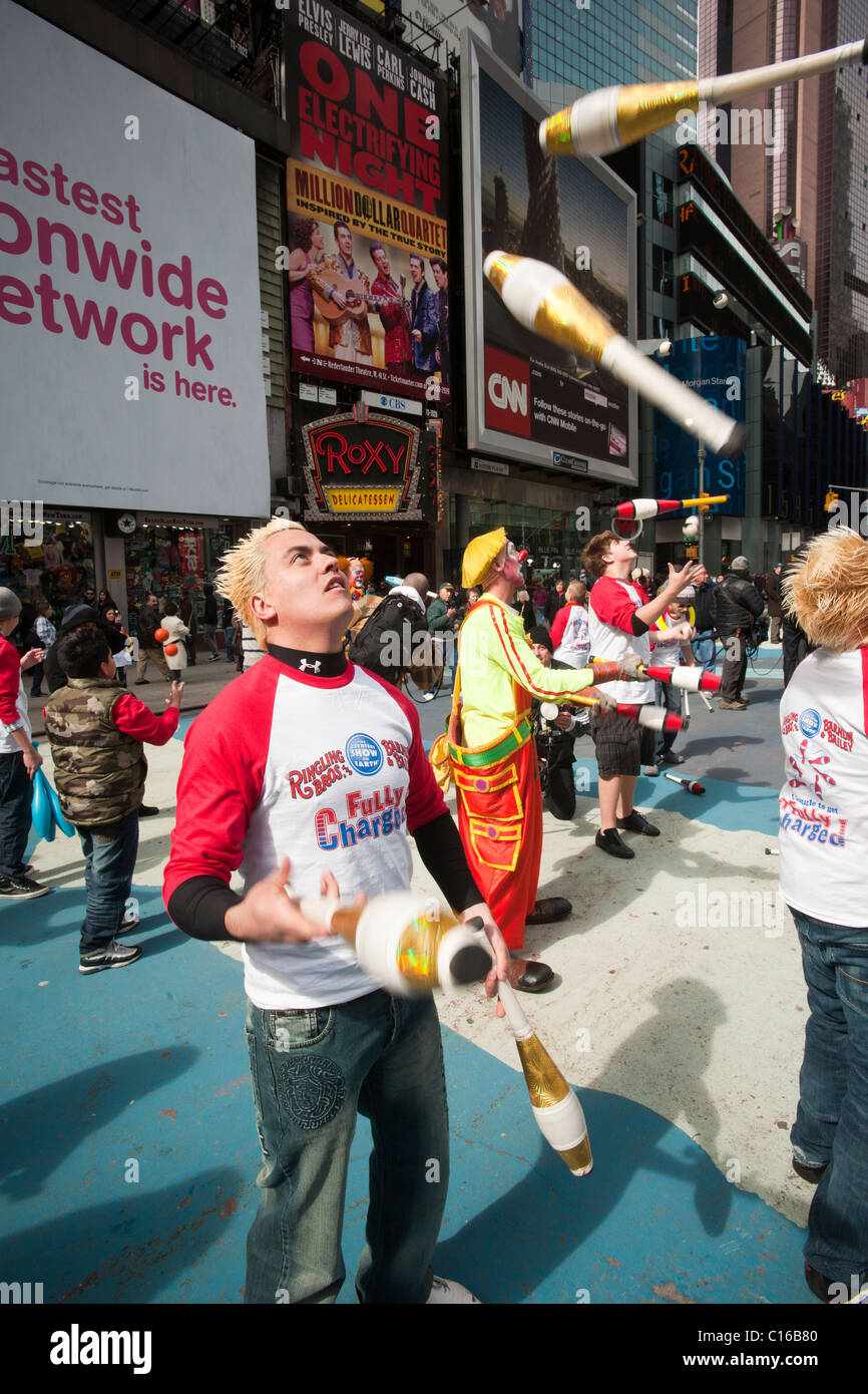 Clowns and other workers from the Ringling Bros. Barnum & Bailey Circus juggle in Times Square as a 'flash mob' Stock Photo