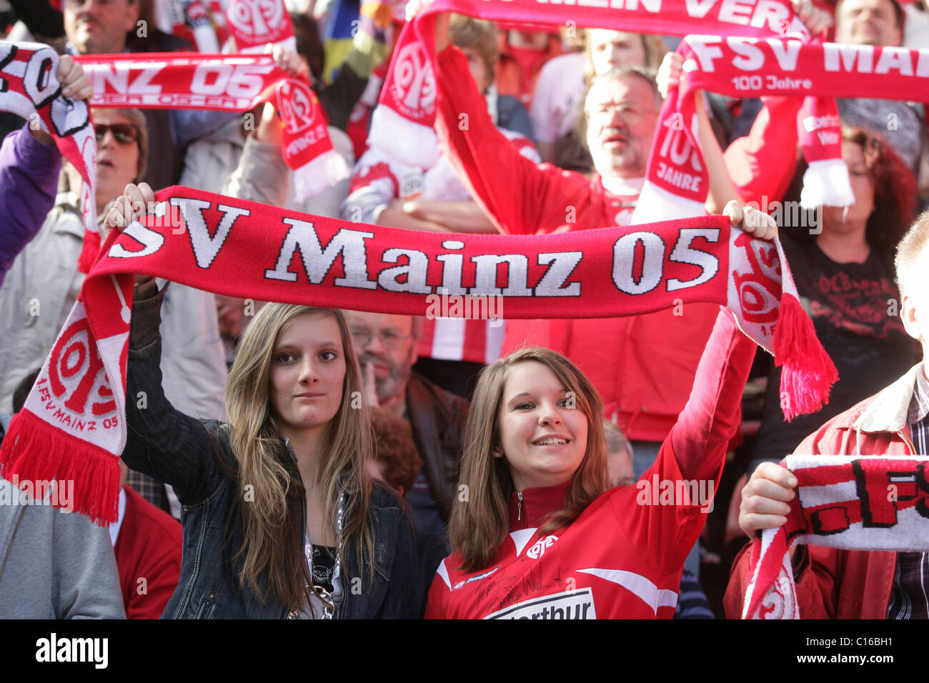 Fans of FSV Mainz 05 showing their team scarves Stock Photo