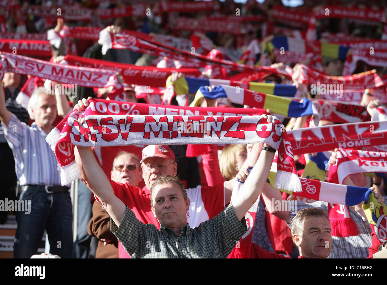 Fans of FSV Mainz 05 showing their team scarves Stock Photo