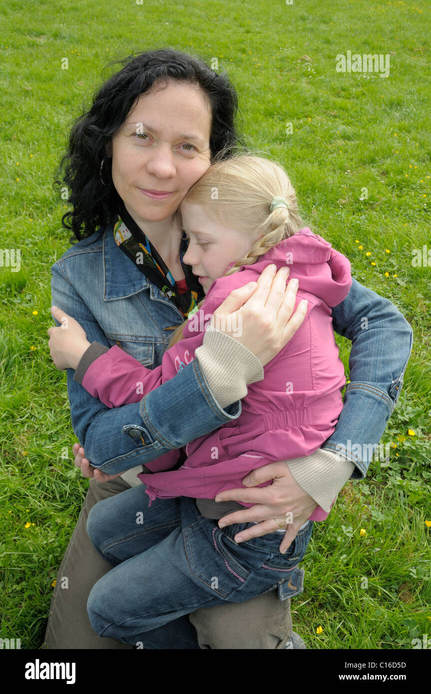 8-year-old girl with her mother Stock Photo