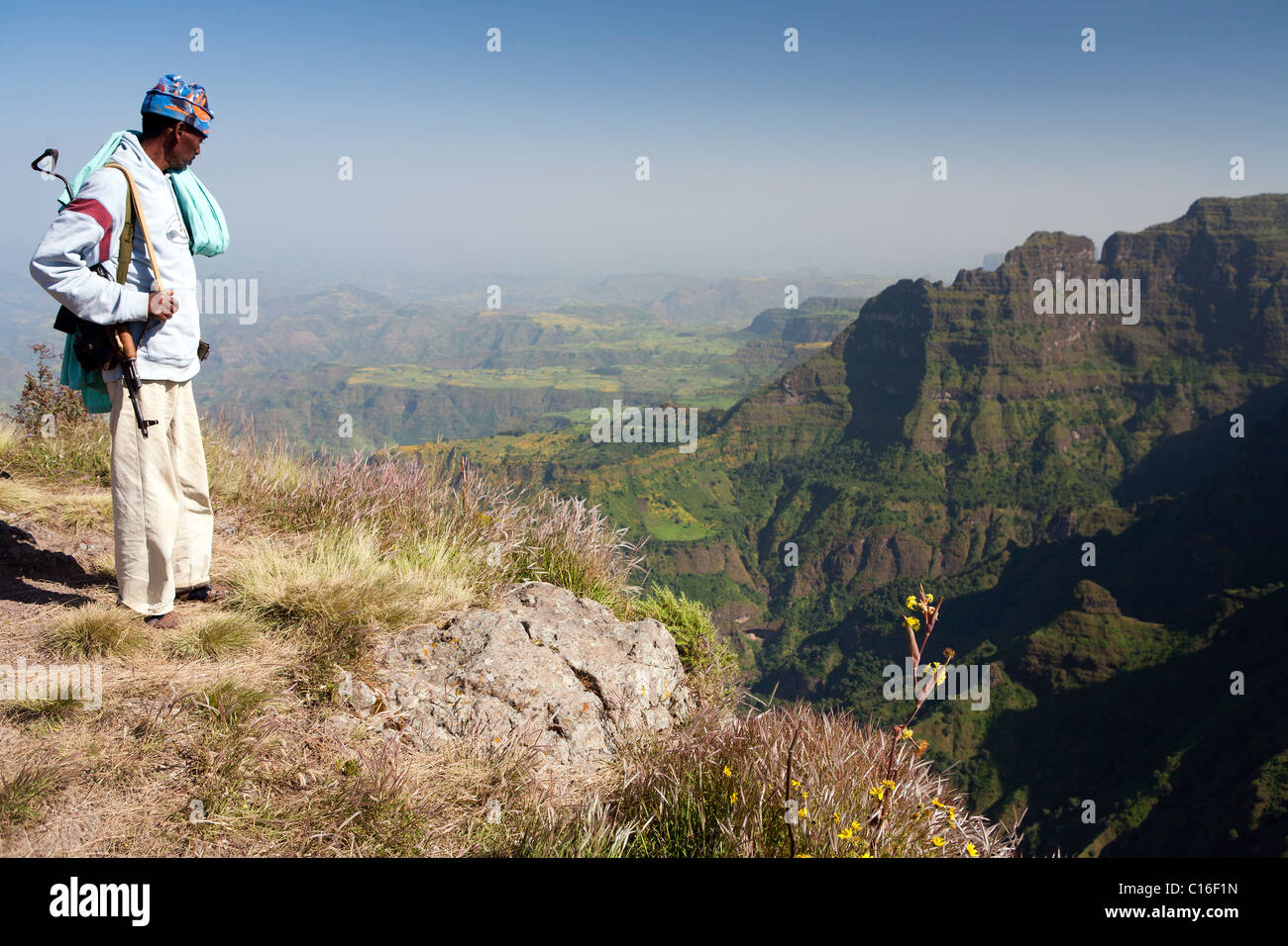 Armed scout at the escarpment edge of the Simien Mountains Stock Photo