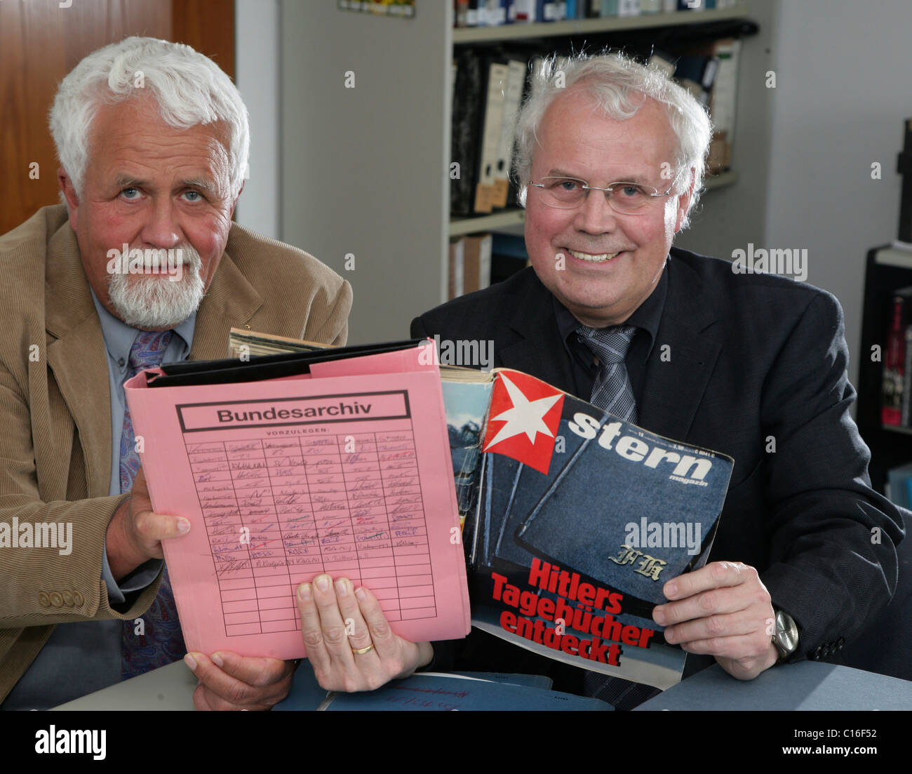 Archivists Klaus Oldenhage, left, and Josef Henke of the Federal Archive of Germany in Koblenz, pictured with an edition of Stock Photo