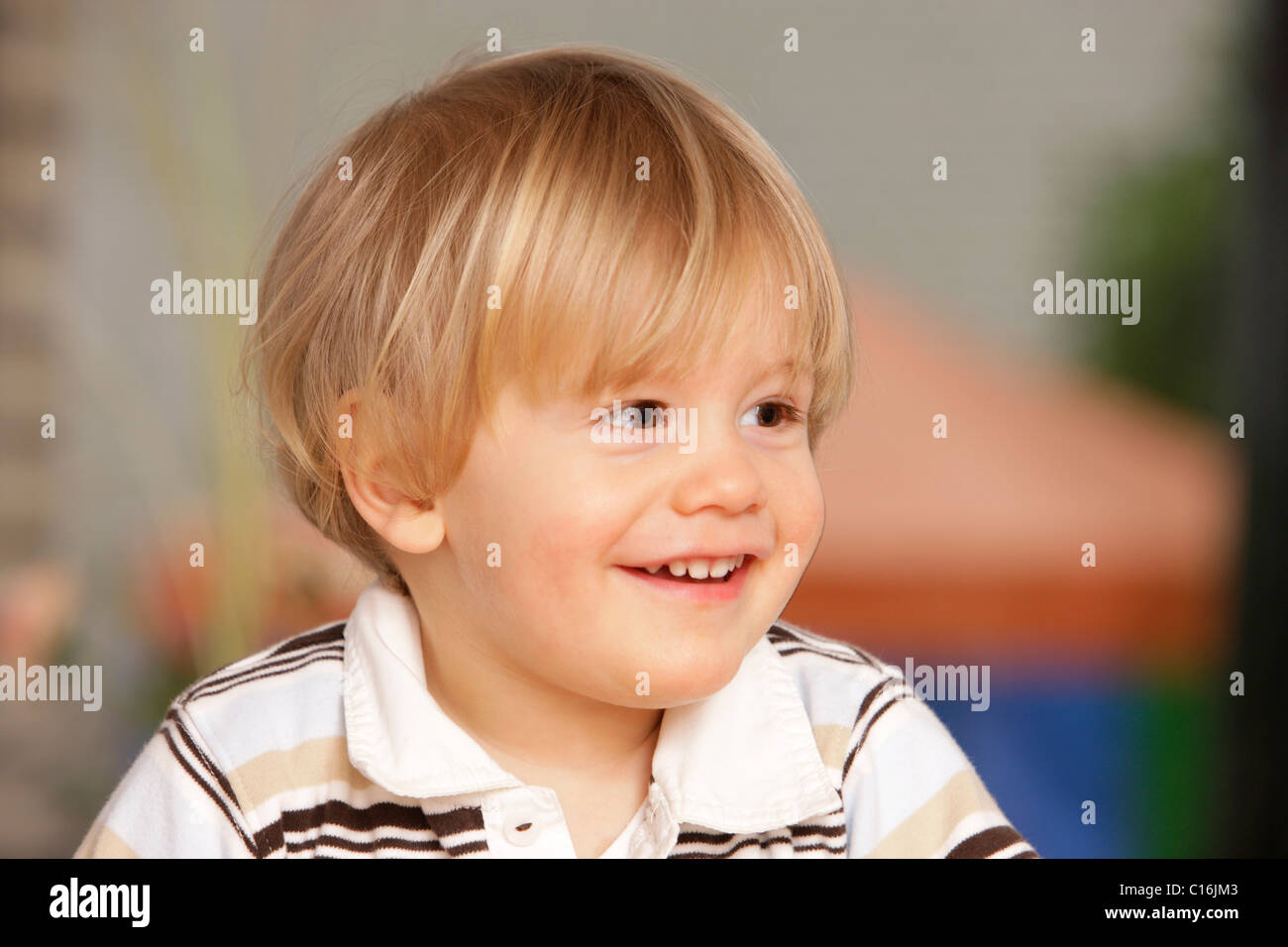 2 year old boy in polo shirt, laughing Stock Photo
