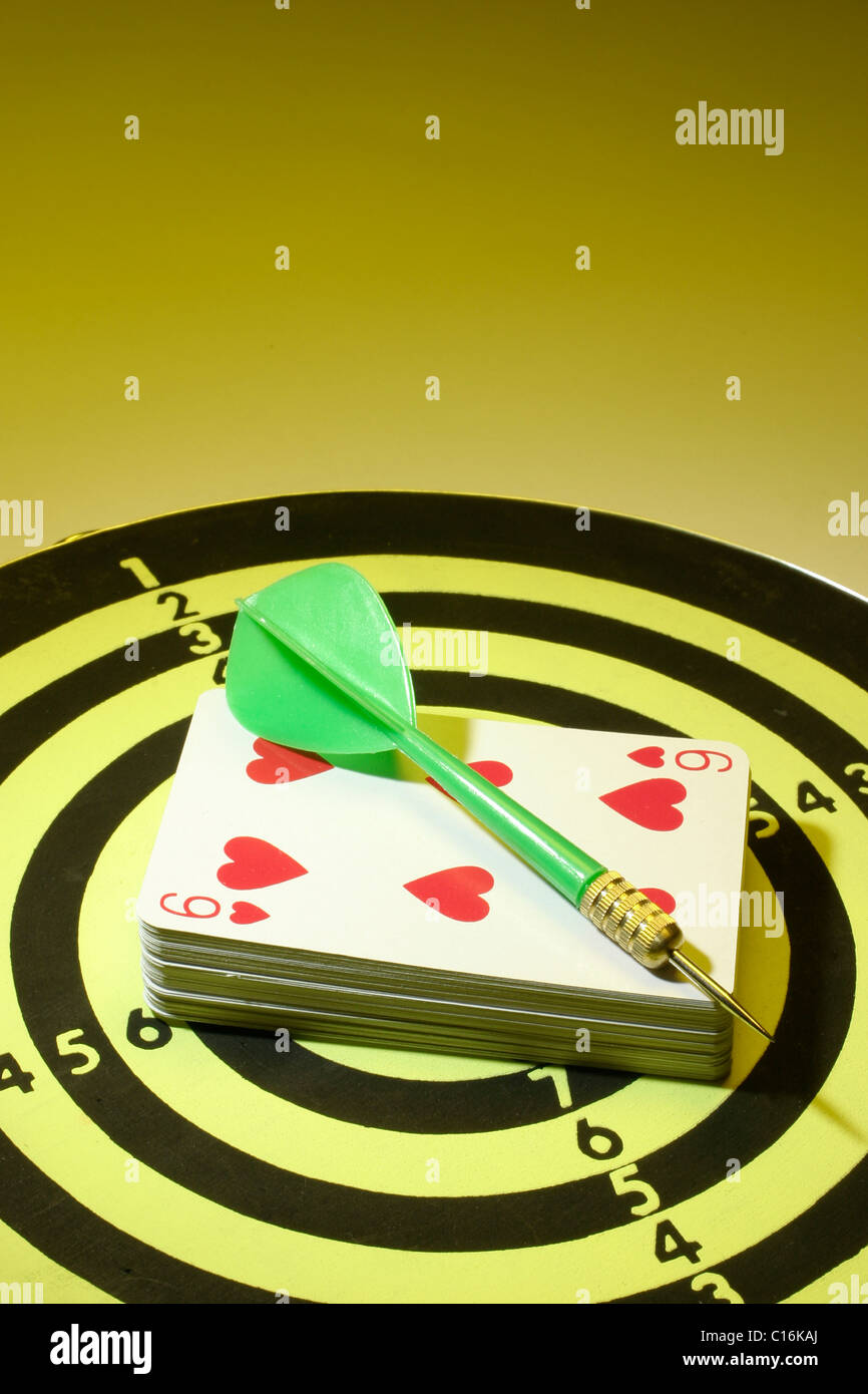 Dart and playing cards on dart board Stock Photo Alamy