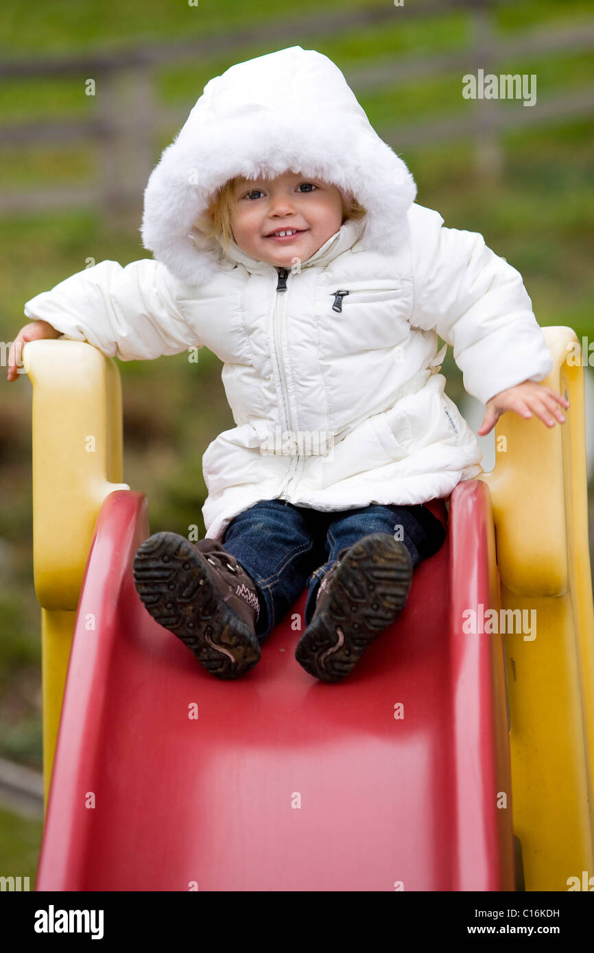 Smiling girl on a slide, Tyrol, Austria, Europe Stock Photo