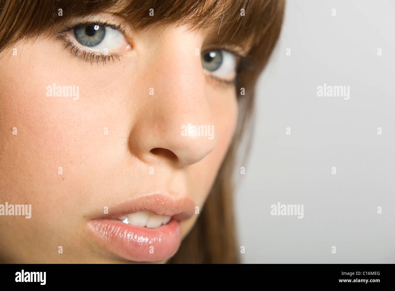 Close-up of the face of a young, dark-haired woman looking at the camera Stock Photo