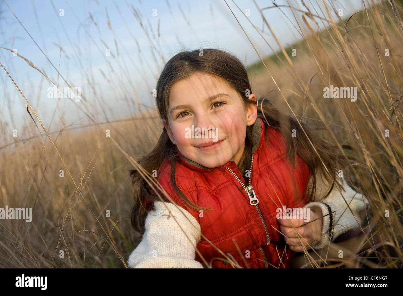 Kid kneeling in the grass hires stock photography and images Alamy