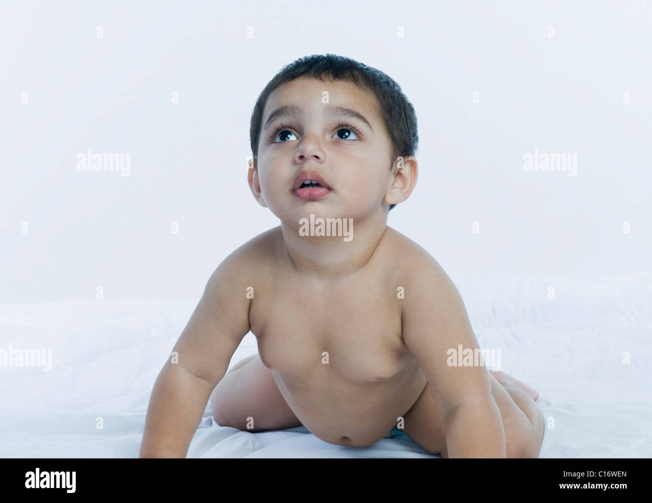 Baby boy crawling on the bed Stock Photo Alamy
