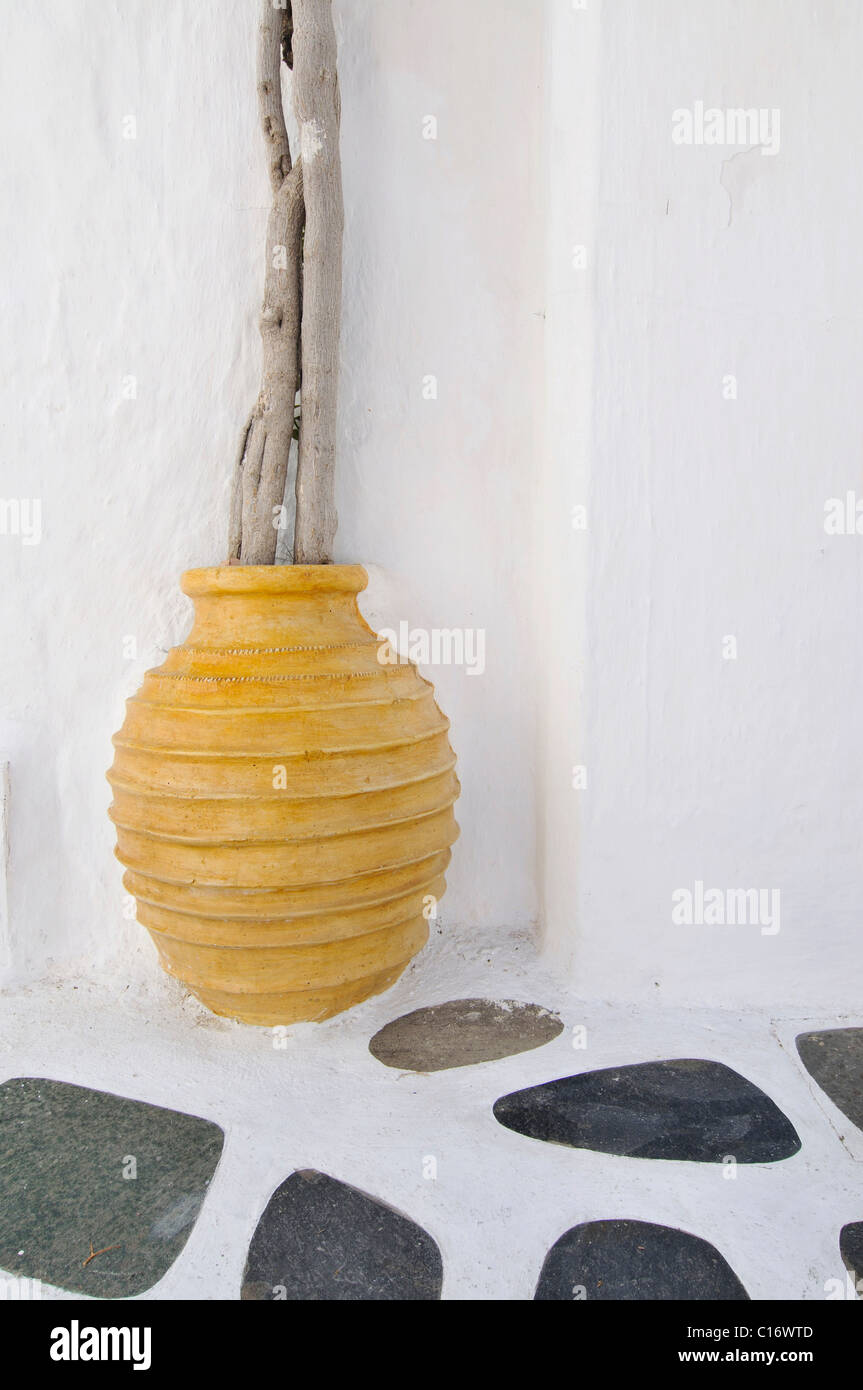 Yellow vase made of clay, mosaik in front of a white wall, Cyclades, Greece, Europe Stock Photo
