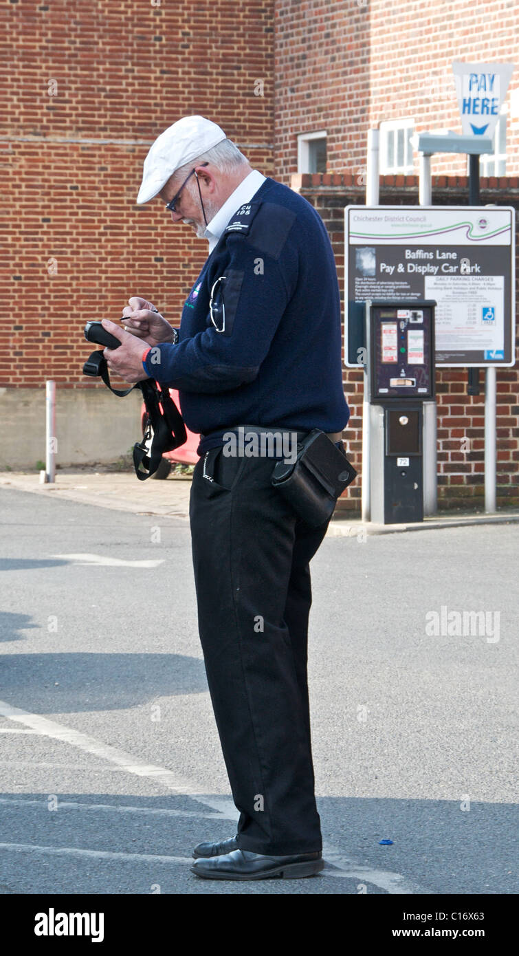 Parking warden employed by local authority to manage car parks UK Stock Photo
