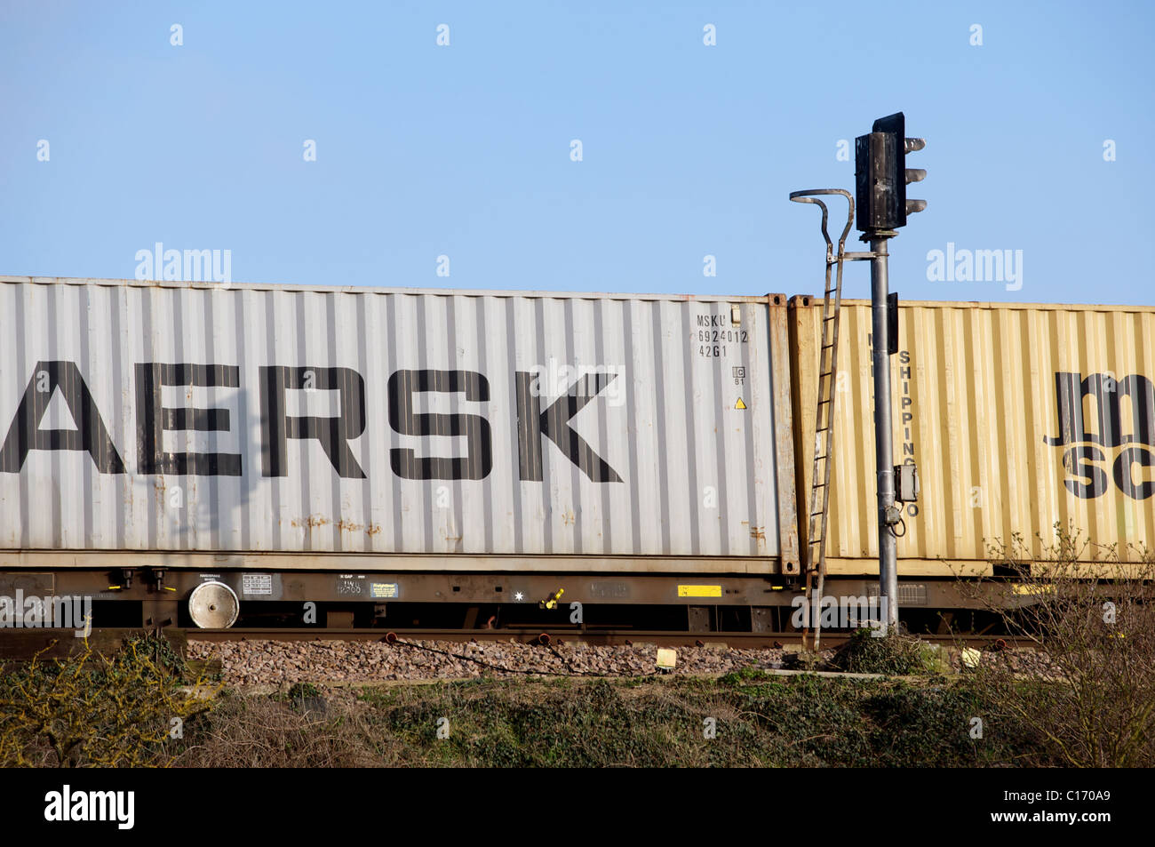 Maersk container transported by rail, UK. Stock Photo