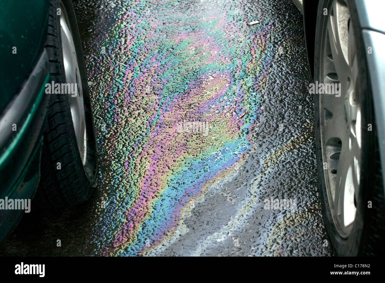 Petrol leaking from car in supermarket car park causing pollution Stock