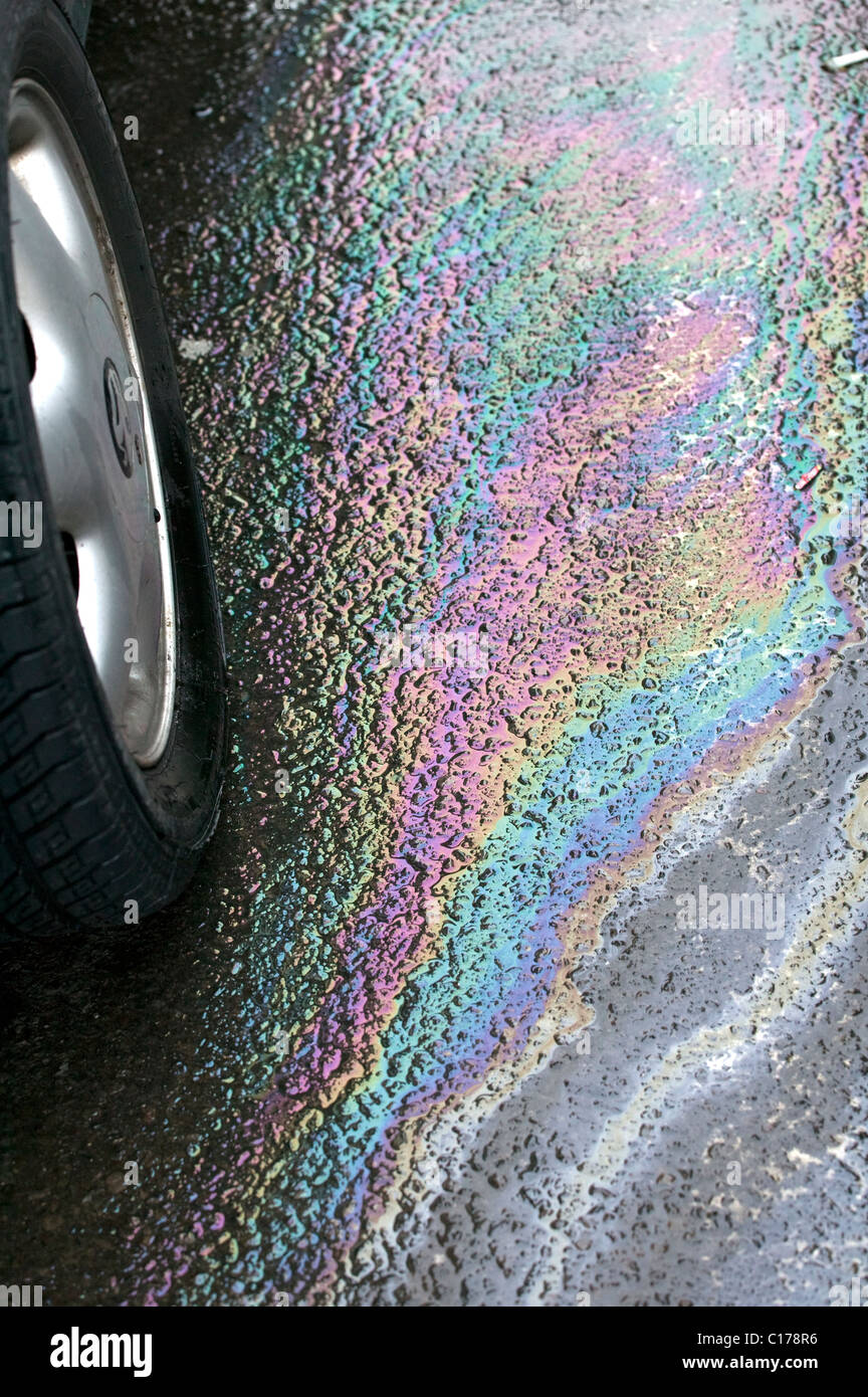 Petrol leaking from car in supermarket car park causing pollution Stock
