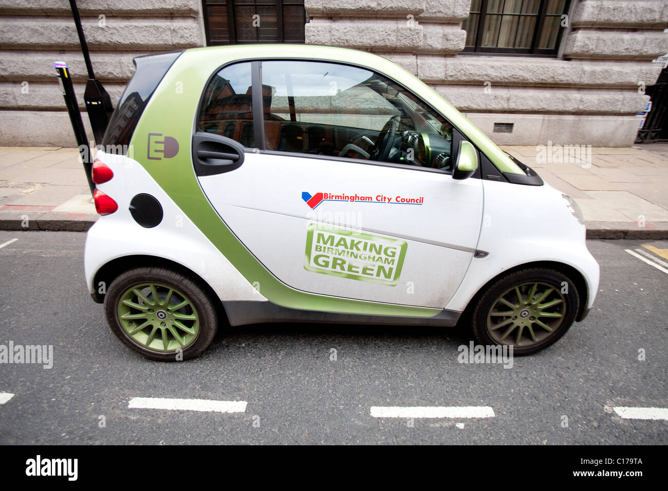 Electric Smart car and charging pint in the centre of Birmingham