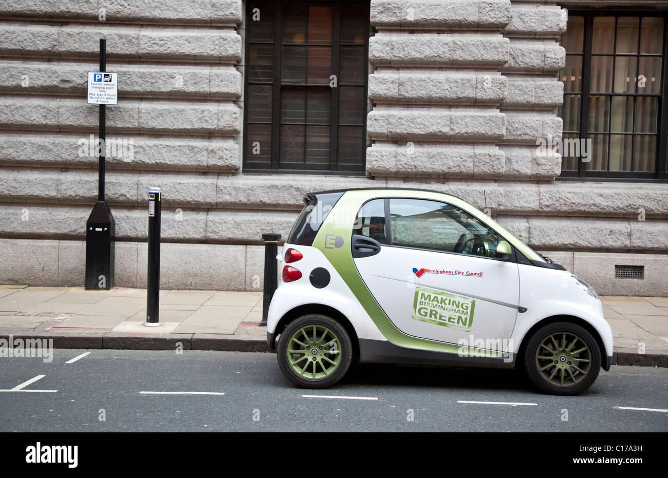 Electric Smart car and charging pint in the centre of Birmingham, England, UK Stock Photo