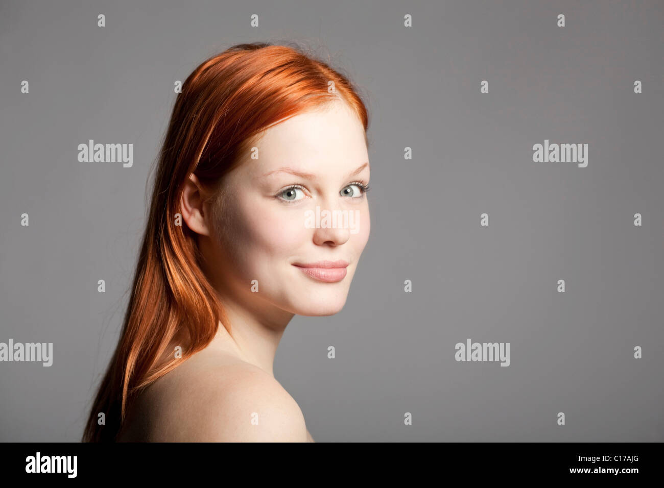Young, red-haired woman looking at the camera Stock Photo