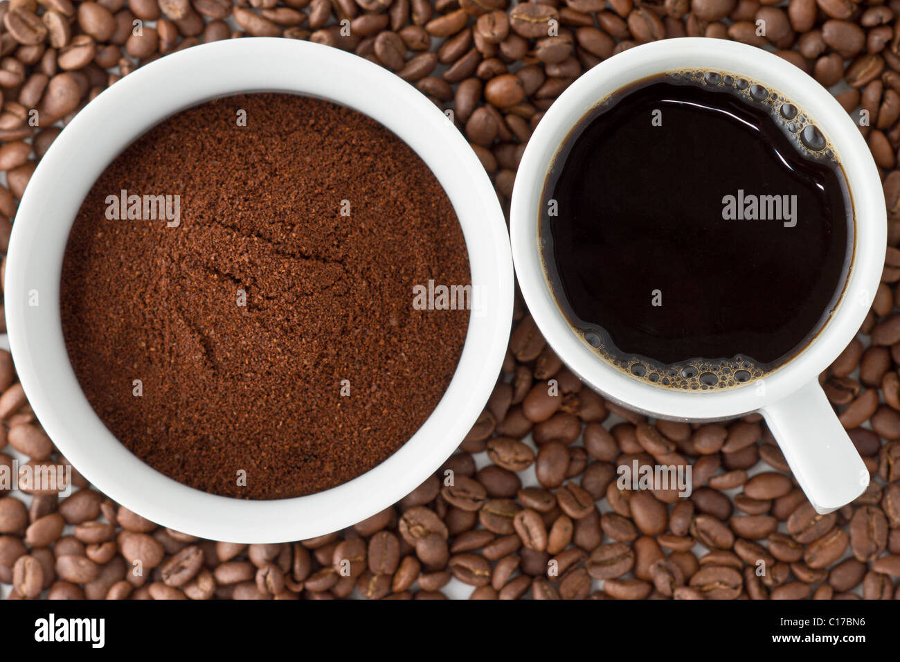 Coffee power in bowl and coffee in cup on top of coffee beans Stock Photo Alamy