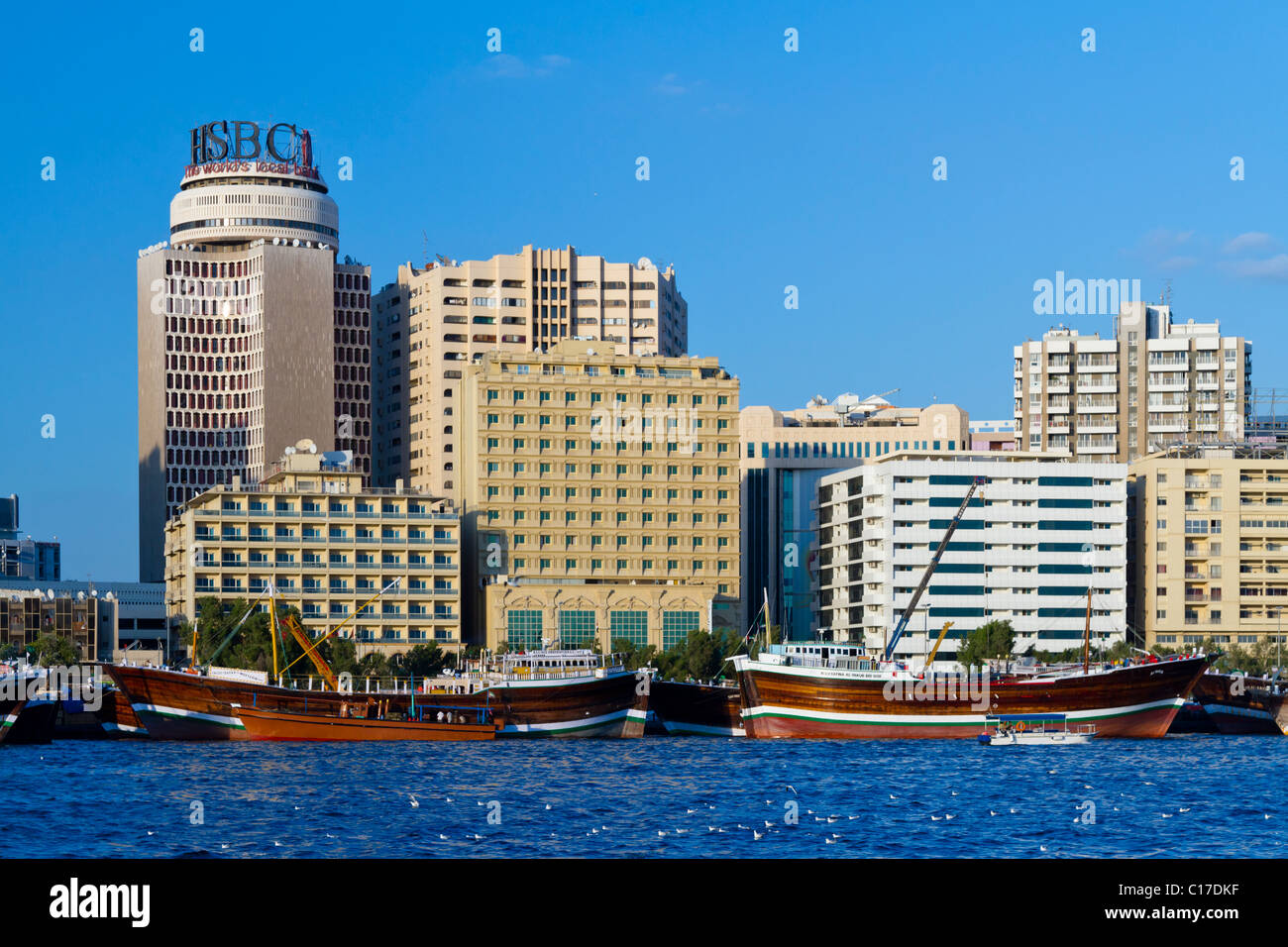 The Dubai Creek skyline with wooden Dow boats in Dubai, UAE. Stock Photo